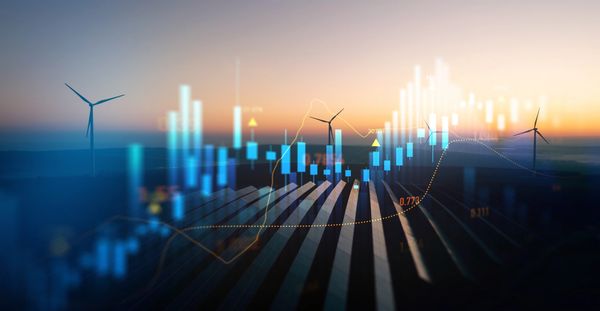 Wind turbines with digital financial charts overlay.