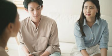 Couple having a serious discussion with a counselor.
