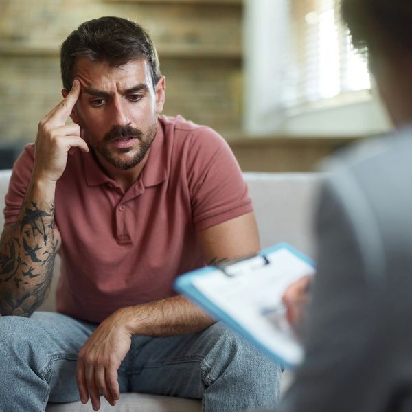 Man looking worried during a session with a therapist.