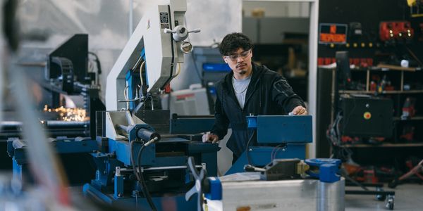 Skilled fabricators creating custom metal parts.