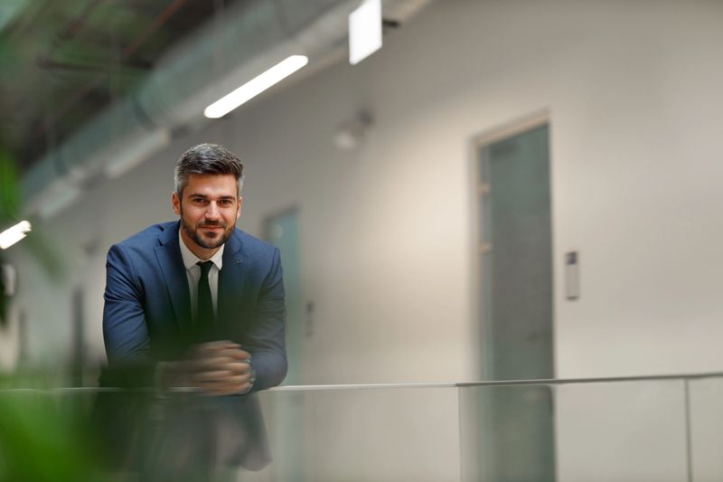 Portrait of a handsome caucasian businessman inside the corporate building.