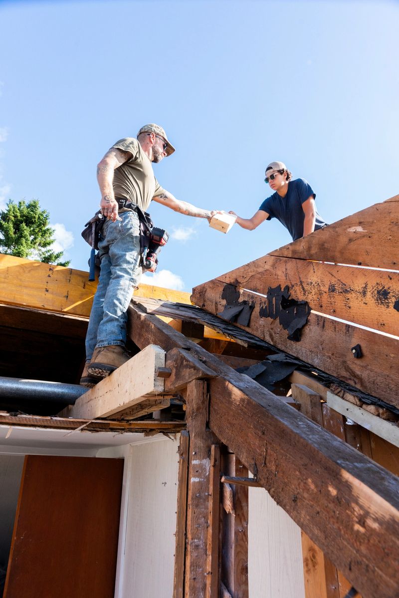 Contractors working on an older home undergoing a renovation.