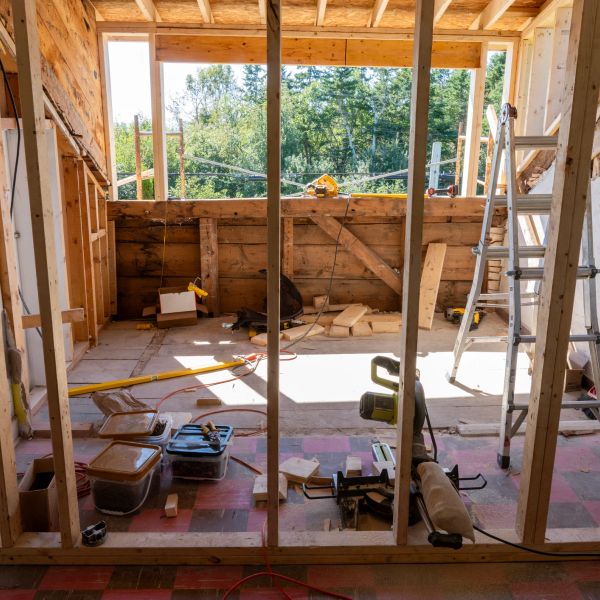 Room under construction with tools and wooden frames.