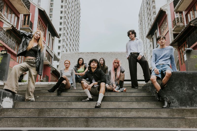 Thai hipster teenagers' friends took a photo together while traveling and resting on their weekend.