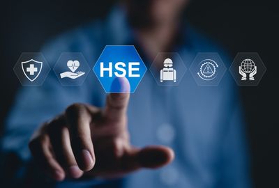 Person interacting with digital icons representing health, safety, and environment (HSE).