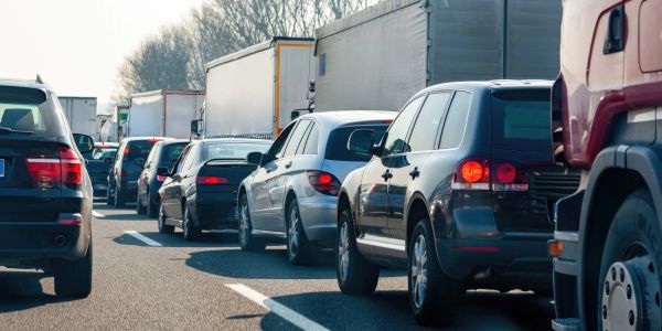 A traffic jam with cars and trucks lined up on a highway.