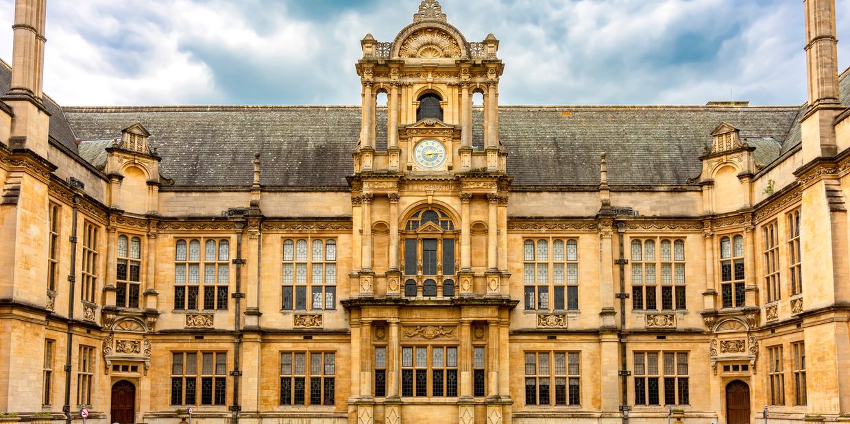 Historic building with clock tower and intricate stone architecture.