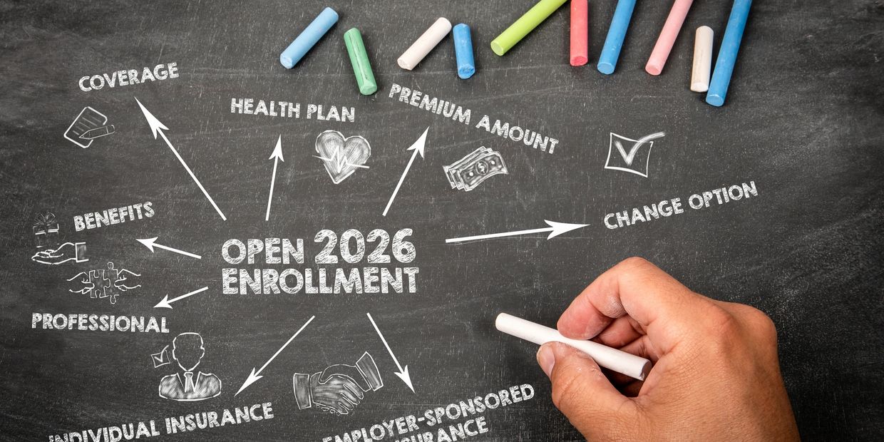Chalkboard showing open 2026 enrollment with related health insurance terms and colorful chalk.