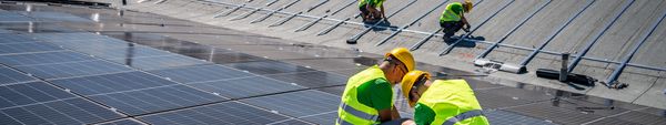 A flat rooftop with white waterproof coating under sunlight.