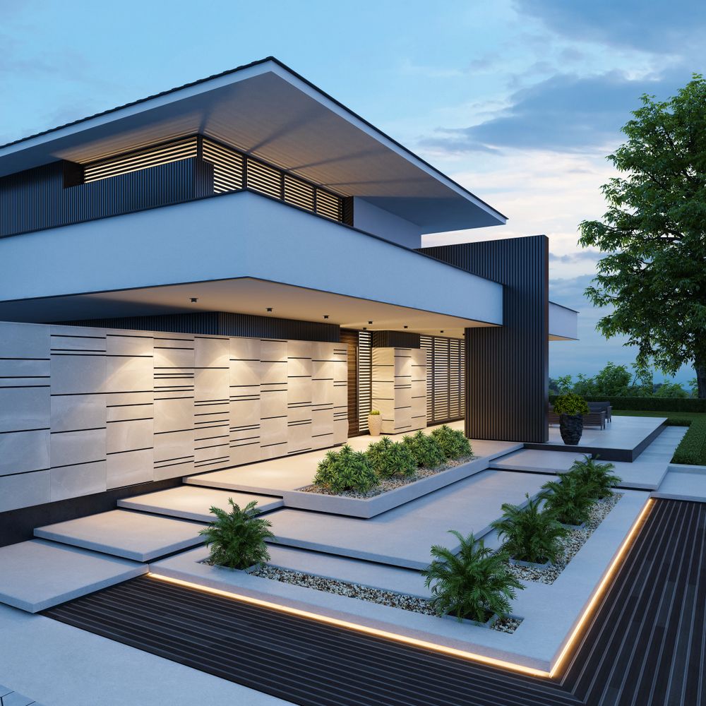 Modern house with sleek lines, illuminated exterior, and landscaped garden at dusk.