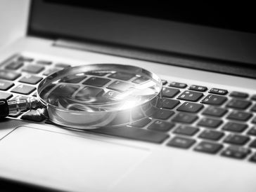 computer keyboard, magnifying glass, analysis, detailed-oriented, investigation