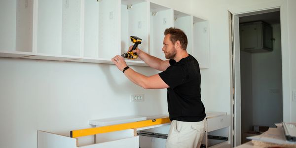 Contractor & builder installing cabinets made by DO It Wise Cabinetry in Raleigh Charlotte Atlanta