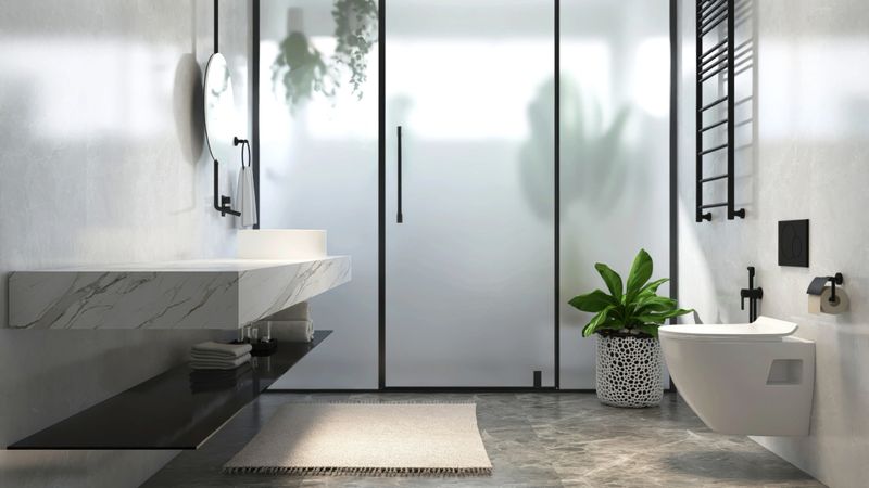 Modern, luxury bathroom with marble vanity counter, white washbasin, round mirror, glass partition to shower enclosure, toilet, wall for interior design, toiletries product background 3D