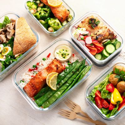 Healthy meal prep with salmon and vegetables in containers.