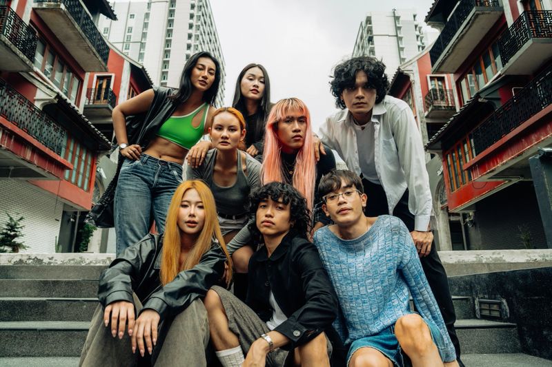 Group portrait of fashionable friends in an urban setting, exuding attitude and style. Ideal for showcasing urban fashion, youth culture, and contemporary lifestyle.