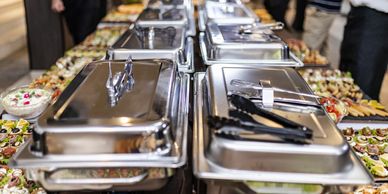 Buffet setup with chafing dishes and food platters.