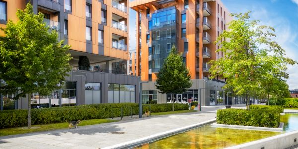 Contemporary waterfront skyscrapers under clear blue skies.