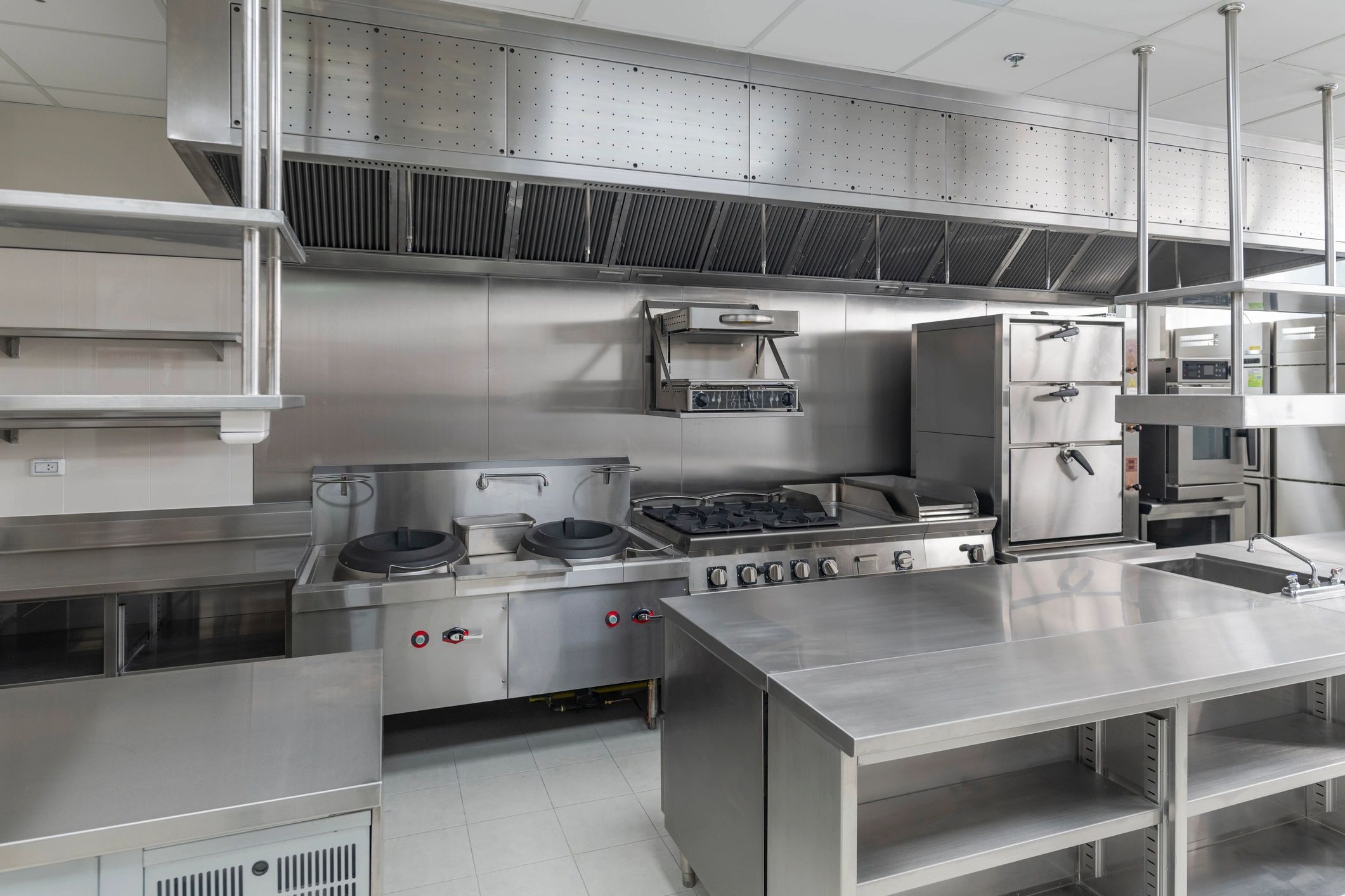 A clean, modern commercial kitchen with stainless steel appliances and counters.