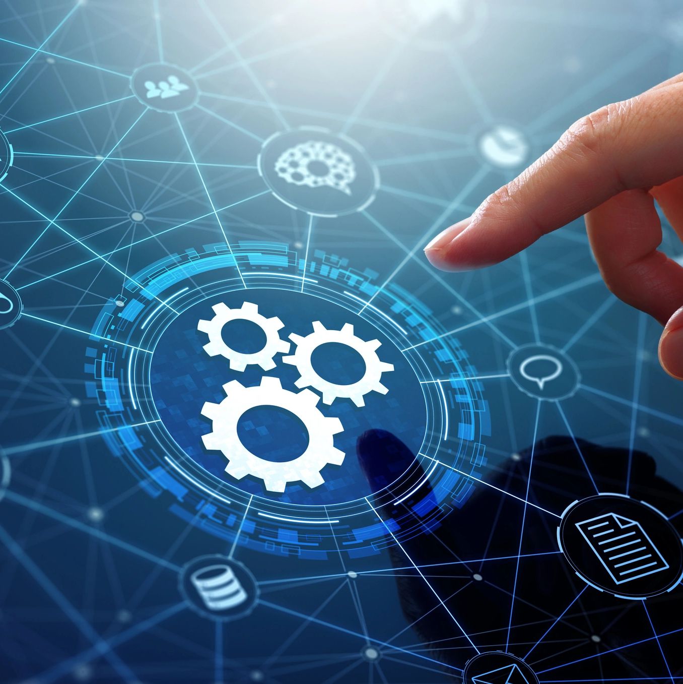 A finger is pointing at a gear icon on a computer screen.