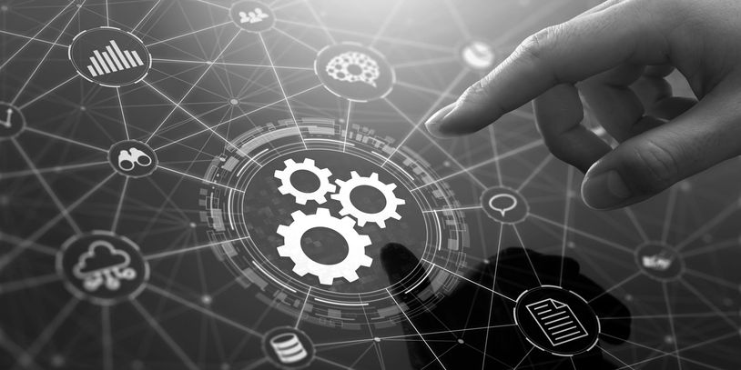 Hand interacting with digital network interface showing gears and icons.