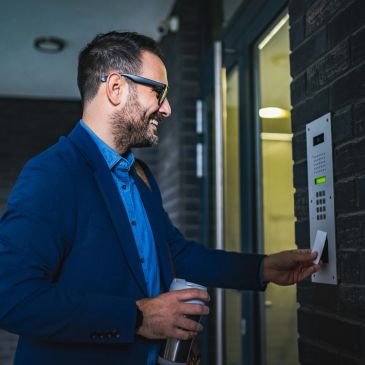 Man using access card to enter building.