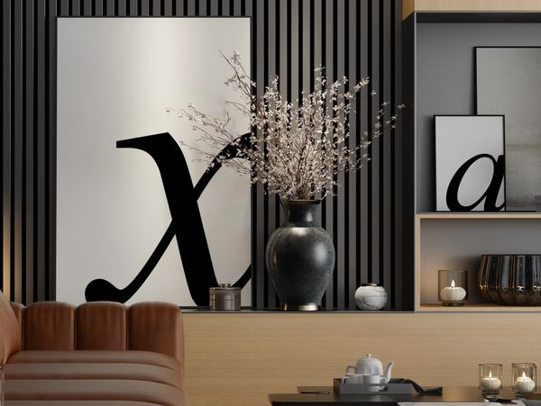 Modern living room with brown leather sofa and decorative black vase with flowers.