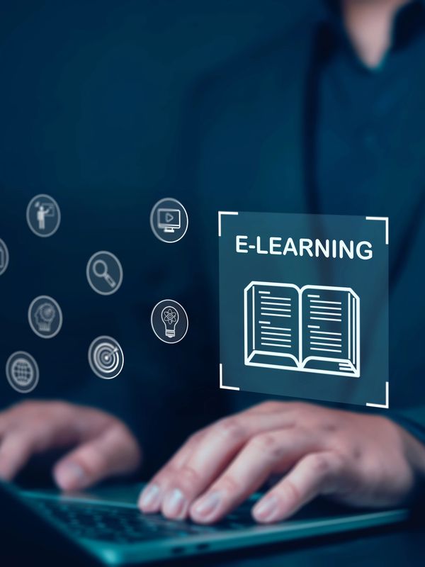 Person using laptop with floating e-learning icons and book graphic.
