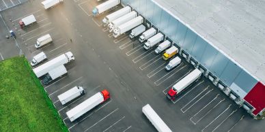 Aerial view of trucks parked at a large distribution center.