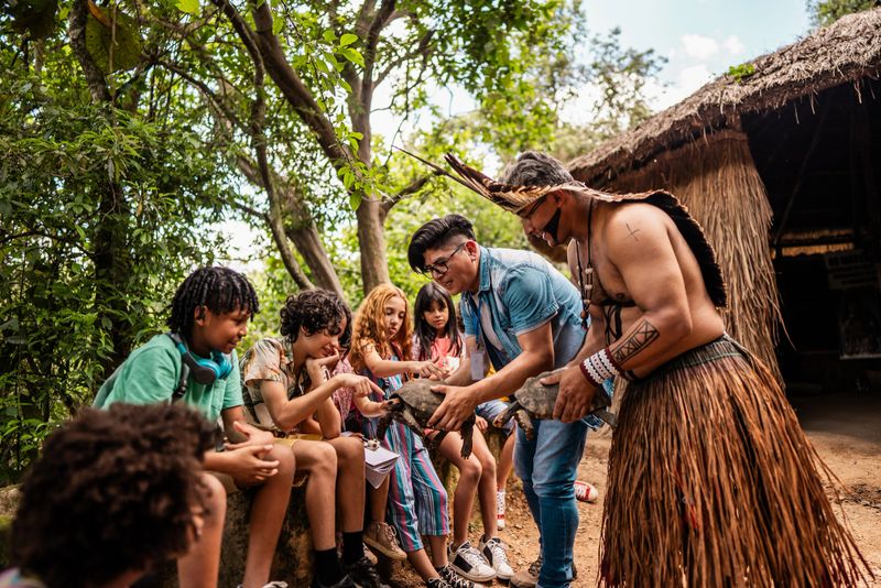 Children caressing turtles during a field trip to an indigenous village in Brazil