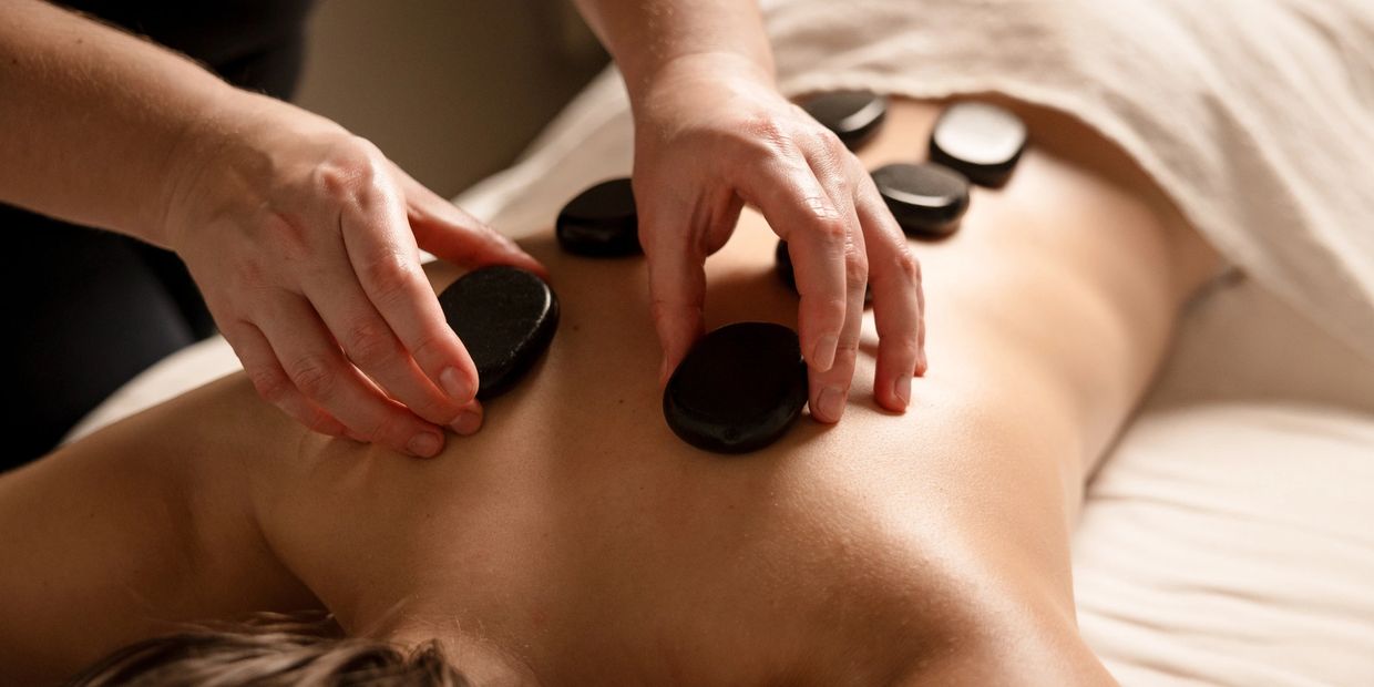 Hot stone massage by a licensed massage therapist, add to your wellness routine and join our loyalty program