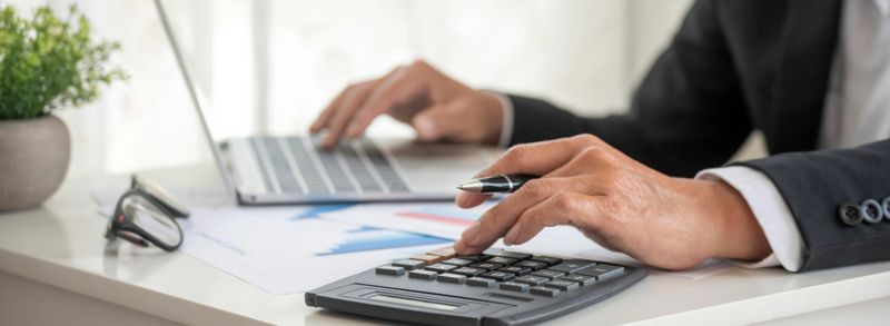 Banner Asian Business man hands using calculator counting tax financial bill. Tax audit Finacial concept. Panorama Close up businessman hands calculating number tax audit planning with copy space