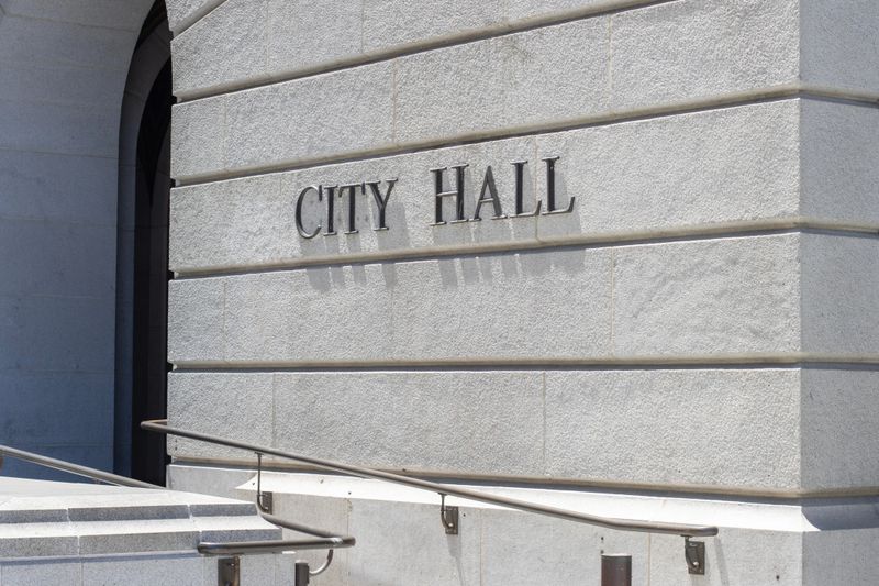 Closeup of the CITY HALL sign seen at one of the entrances to the Los Angeles City Hall in Southern California.