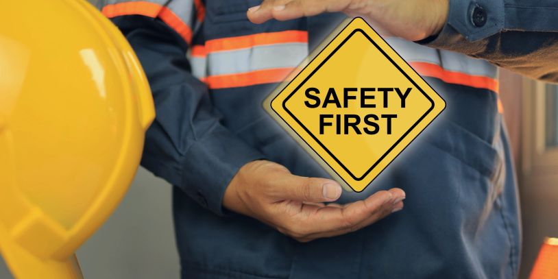 Worker emphasizing safety first with a protective helmet.