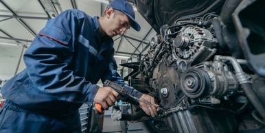 Technician inspecting diesel engine components.
