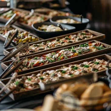 A buffet spread with a variety of appetizers and breads.
