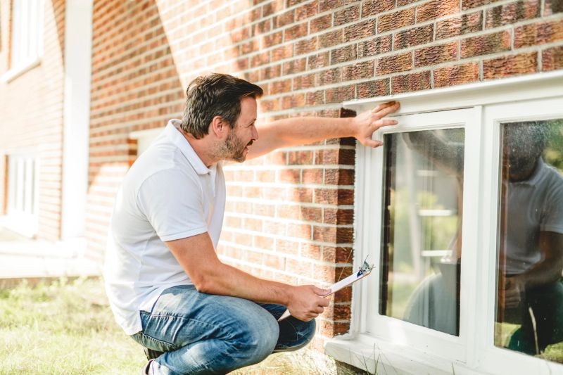 A man inspecting house window outside on day light