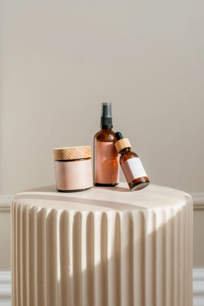 Minimalist skincare bottles on a pedestal.