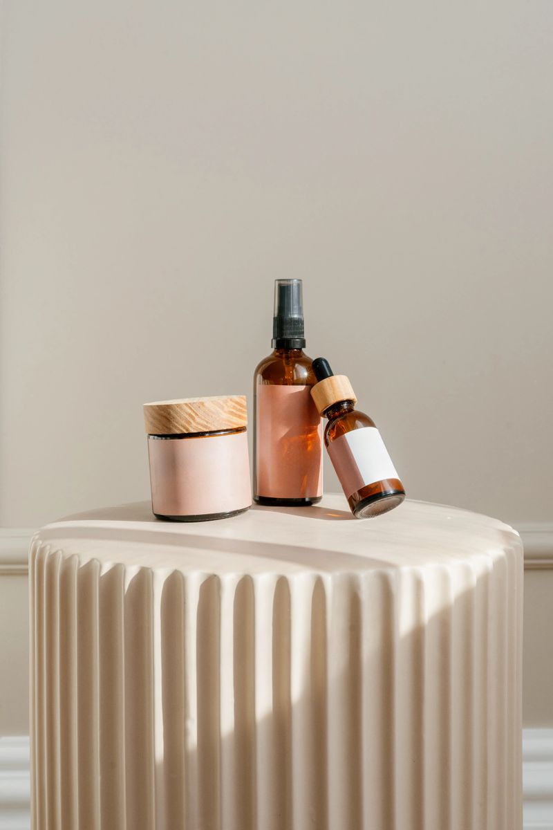Vertical shot of beauty products, including a jar with face cream, spray bottle and dropper with anti wrinkle serum, rest on a stylish pedestal. Advertising concepts of skin care cosmetics