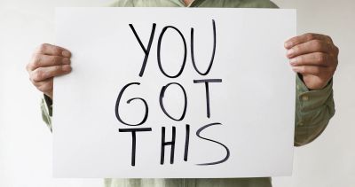 Person holding a sign that says 'YOU GOT THIS'.