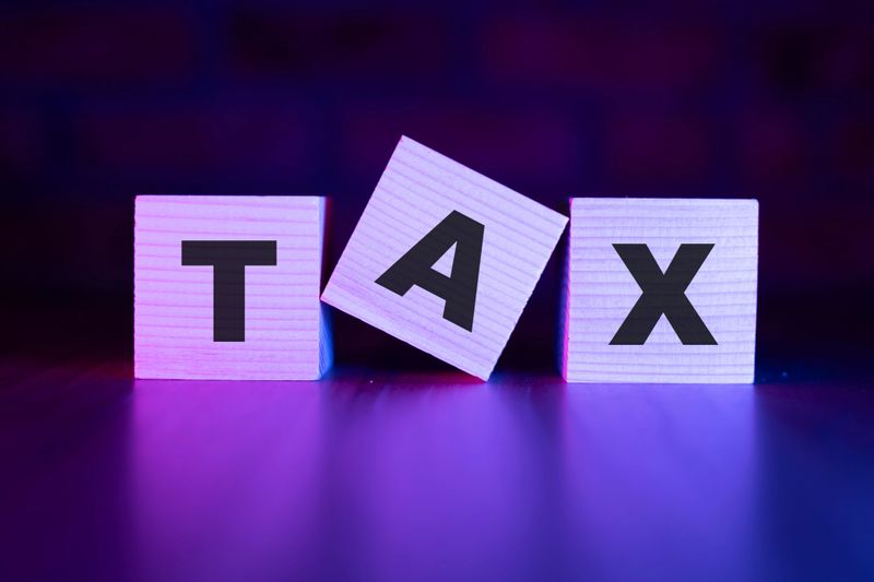 Tax word with wooden blocks on table