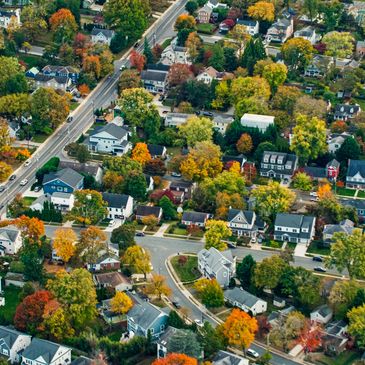 Aerial view of a suburban neighborhood with colorful autumn trees in Central Massachusetts and Pioneer Valley