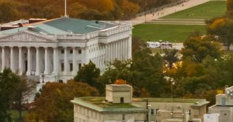 Aerial view of Washington, D.C. at golden hour with the U.S. Capitol and Washington Monument