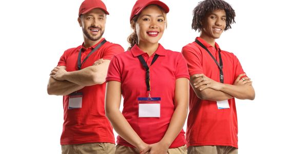 Three smiling delivery workers in red uniforms with name badges.