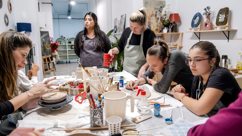 A clay-shaping art event held in an art studio with a group of people