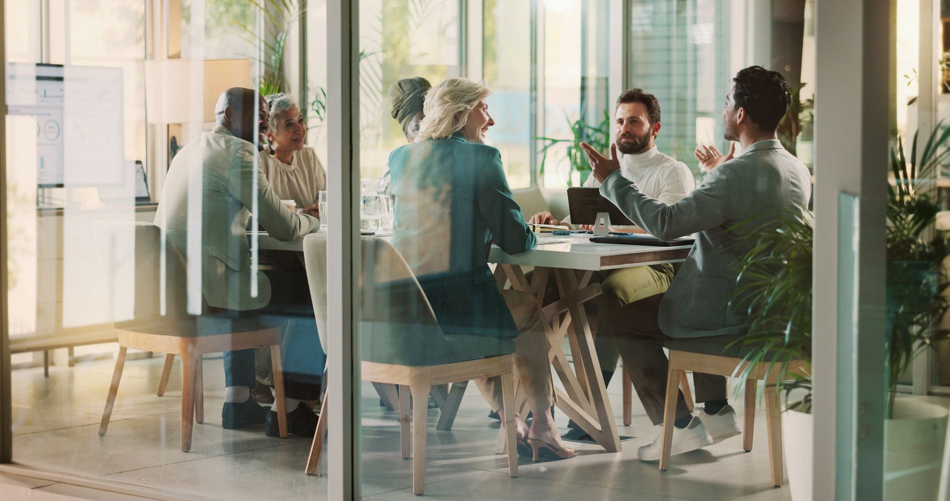 Diverse team discussing ideas in a modern office meeting room.