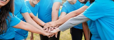 Team joining hands in unity.