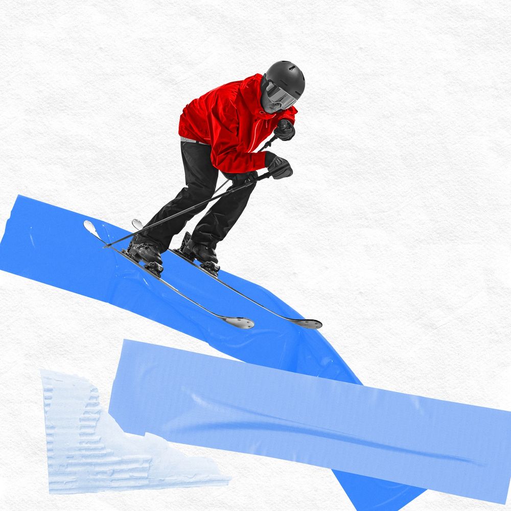 Skier in red jacket jumping on an abstract blue and white background.
