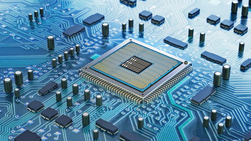Detailed architecture of a computer chip nestled on a circuit board. The surrounding electronic components highlight modern technology's complexity and innovation