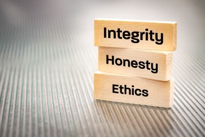 Wooden blocks labeled Integrity, Honesty, and Ethics.