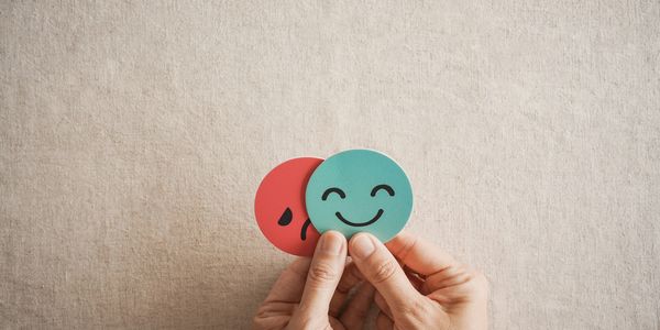 Dominant happy face over sad because they have control of their anxiety